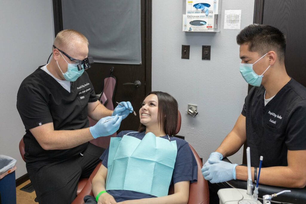 Dentist performing dental procedure on patient in Rapid City SD with gentle care