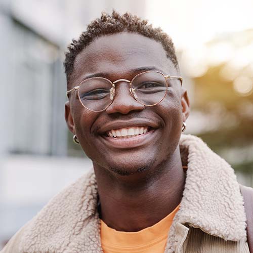 Smiling man with glasses in a fleece-lined jacket