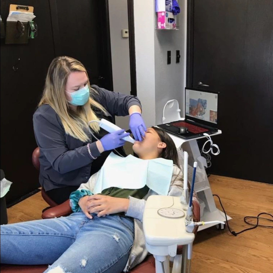 Dentist performing dental exam on patient in Rapid City SD dental office