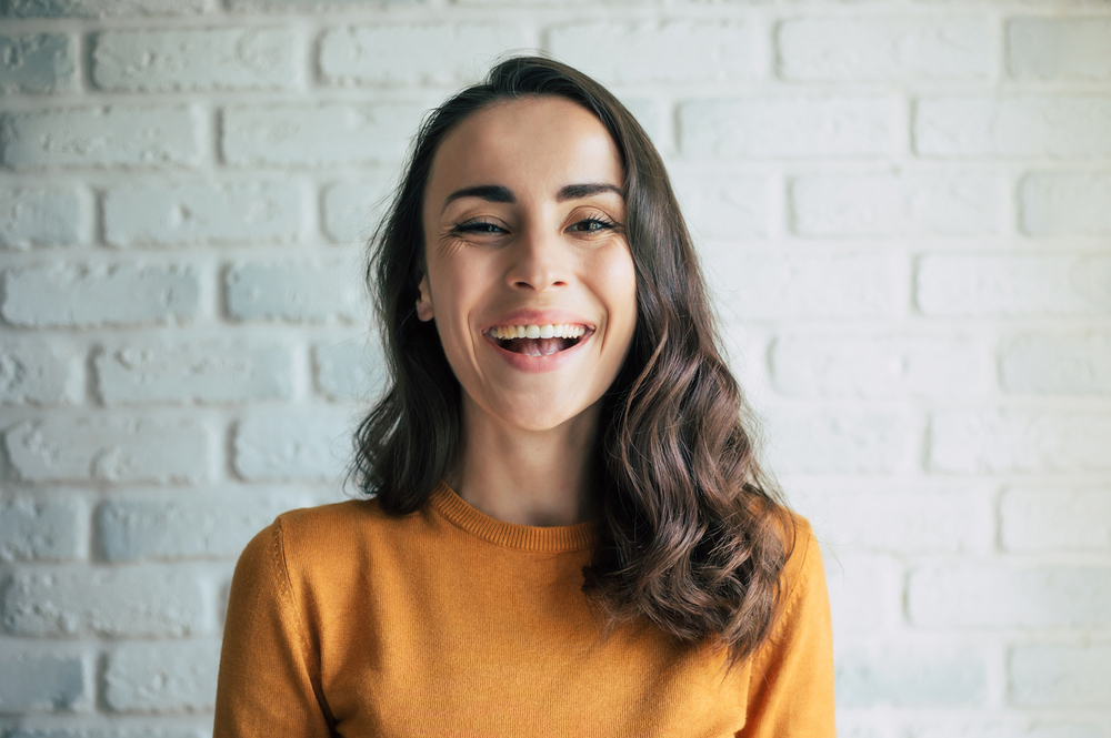 Woman smiling with bright healthy teeth after dental care and braces in Rapid City SD