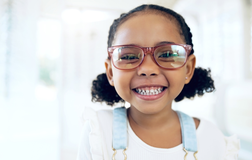 Child smiling with healthy teeth after children’s dentistry visit in Rapid City SD