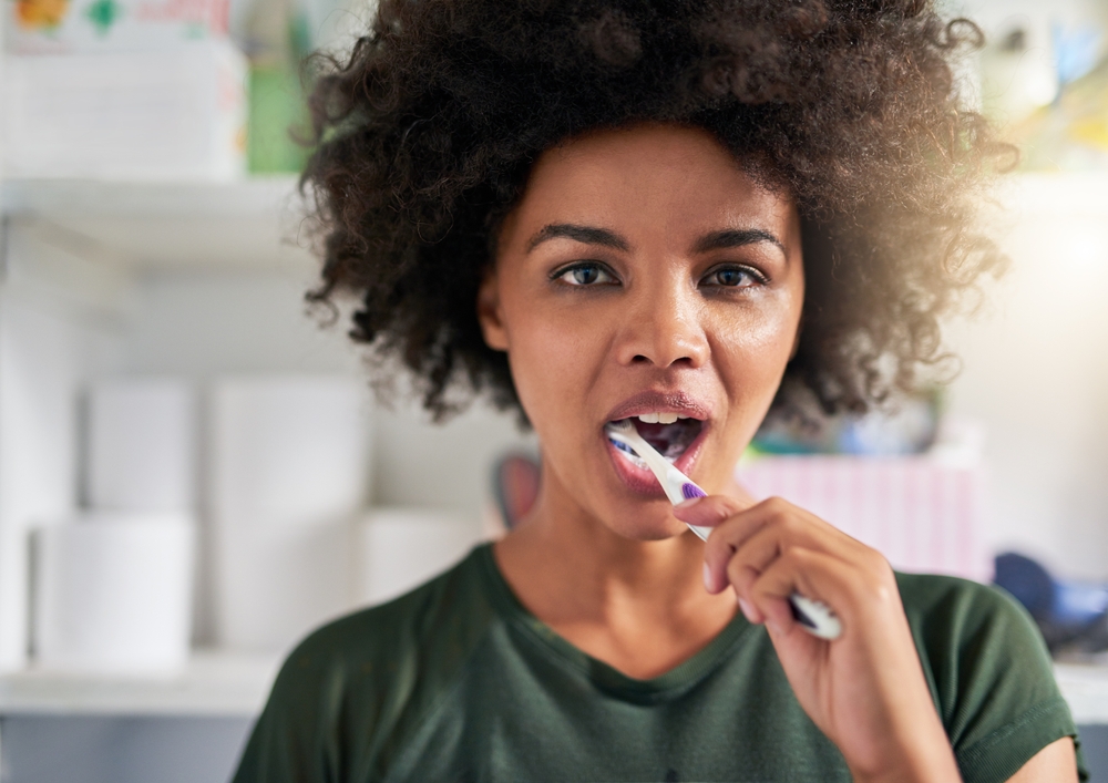Woman brushing teeth showing proper oral hygiene in Rapid City dental care