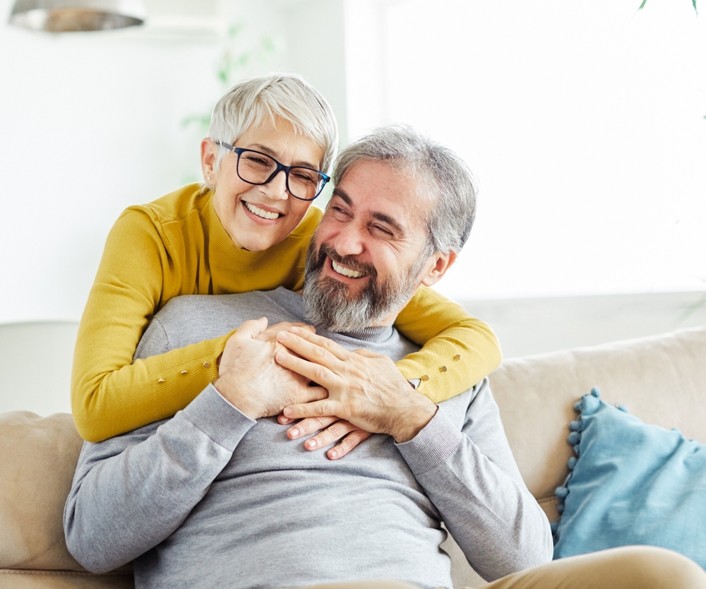 Happy smiling couple embracing, representing positive dental patient experience and confidence